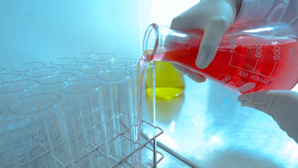 Quality control scientist working with test tubes
