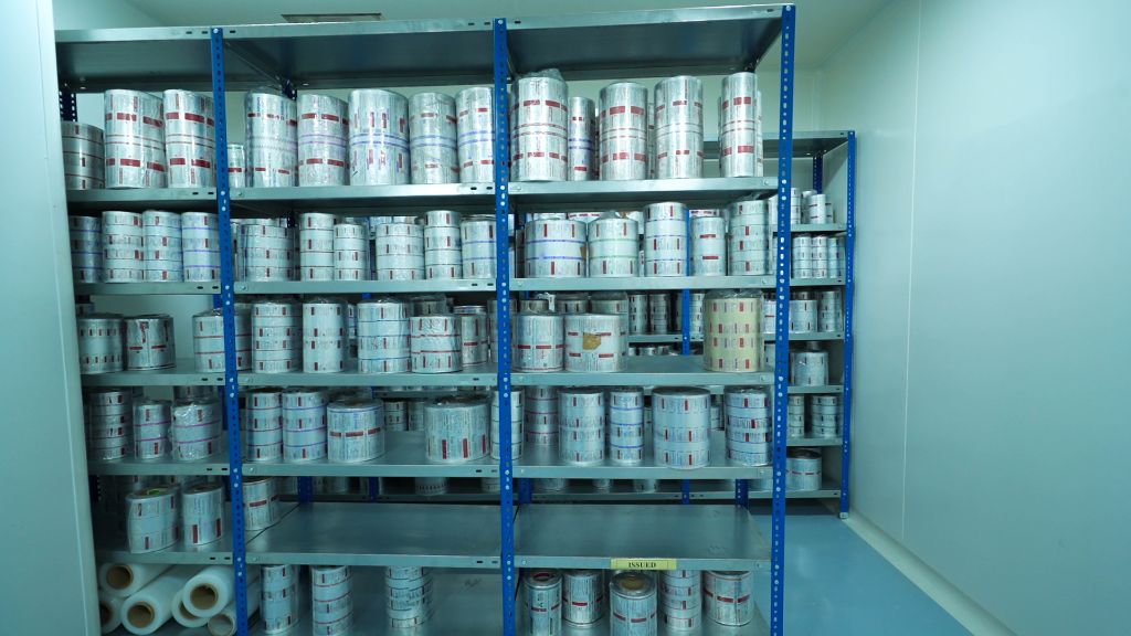 Packaging foil rolls on storage shelves