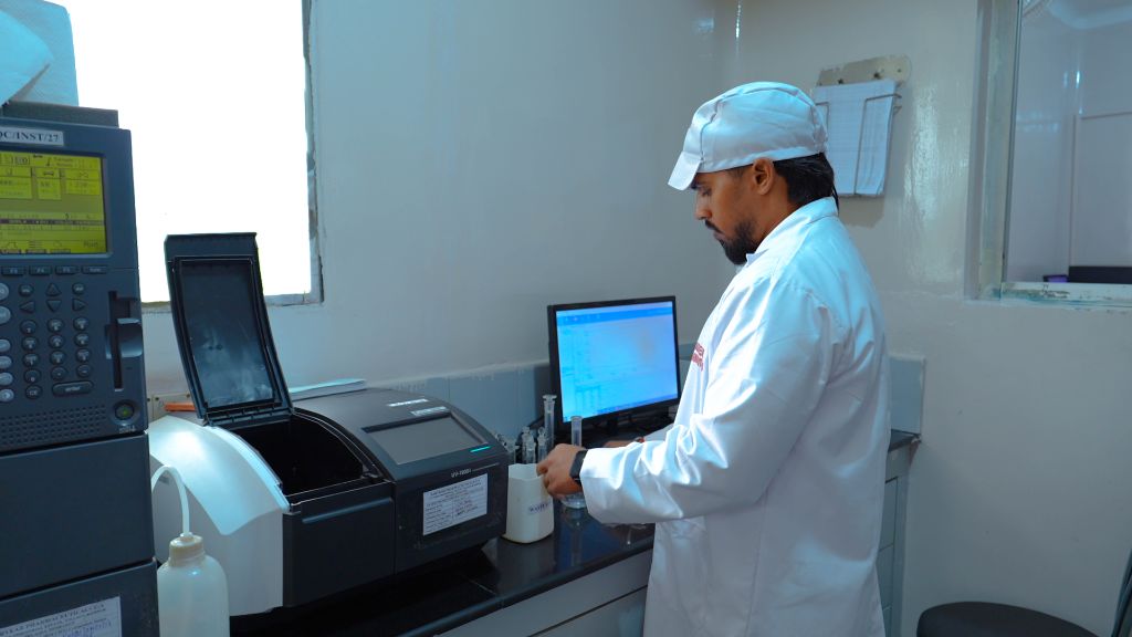 Lab technician with spectrophotometer at QC bench