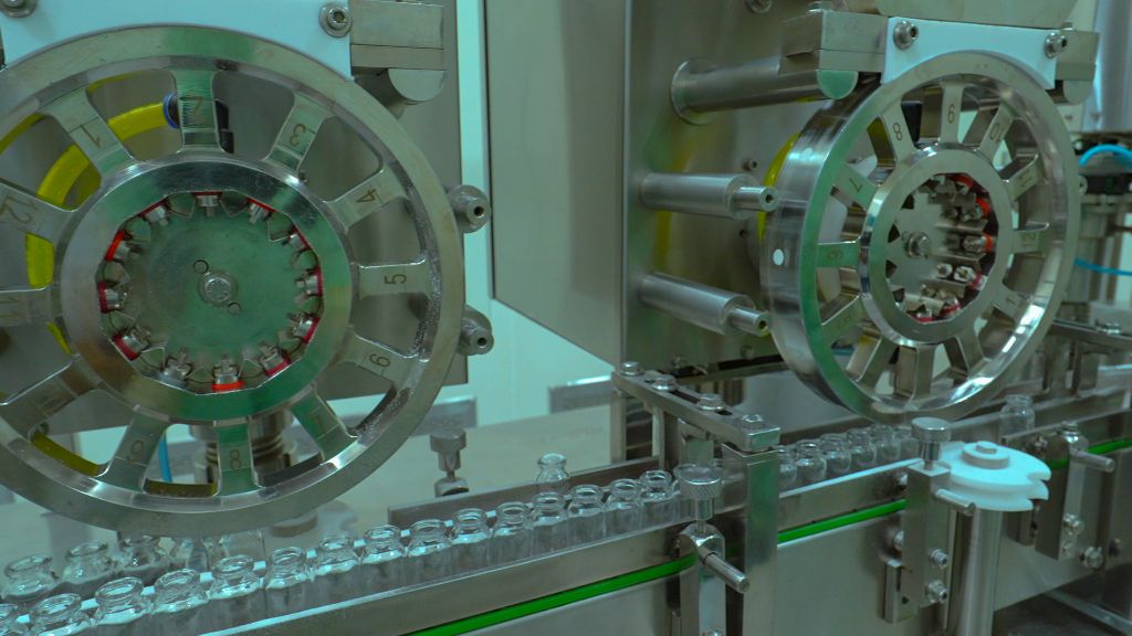 Close-up of glass vials on packaging conveyor